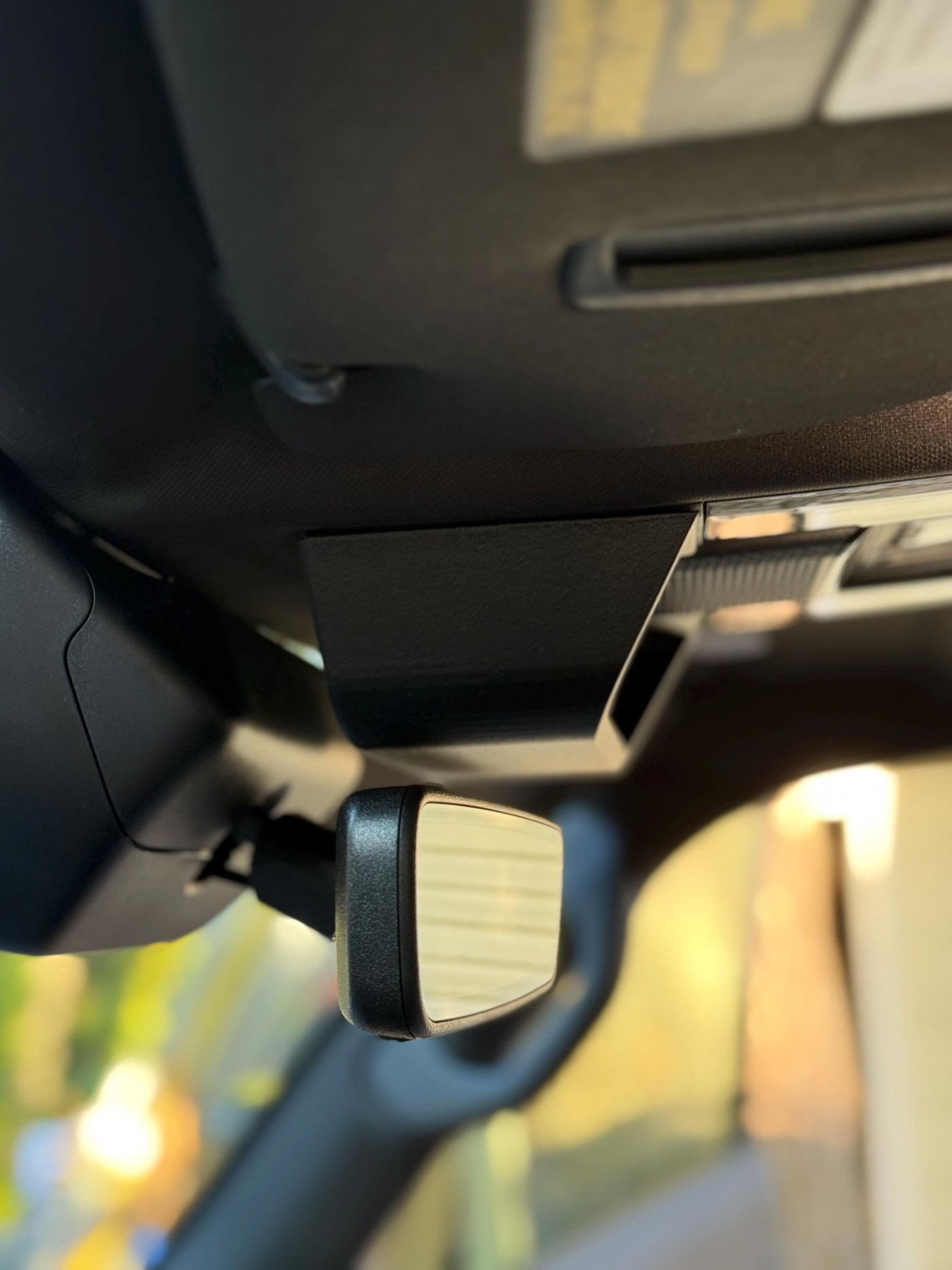 Close-up of precision-fit overhead glasses holder for Lexus GX550